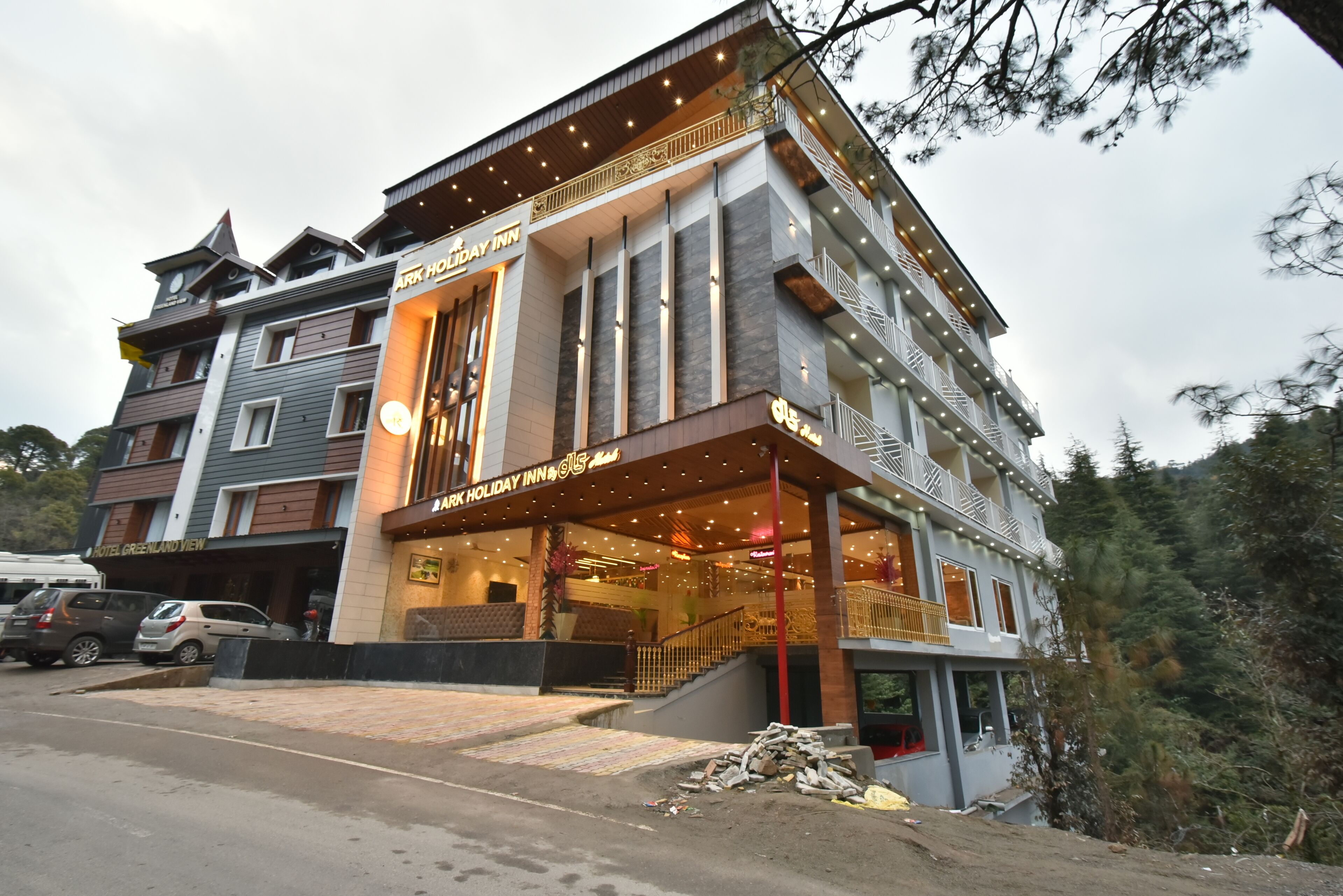 A multi-story hotel with a modern design, featuring balconies and large windows.