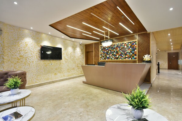A modern reception area with a wooden ceiling, a colorful mosaic wall, and marble flooring. - Ark Holiday Inn By DLS Hotels (Dalhousie)