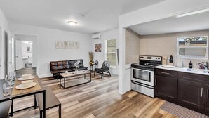 A modern kitchen with dark cabinets, a stove, and a sink. - Hallandale Mins From Beach & Aventura Mall HN01 (Hallandale Beach)