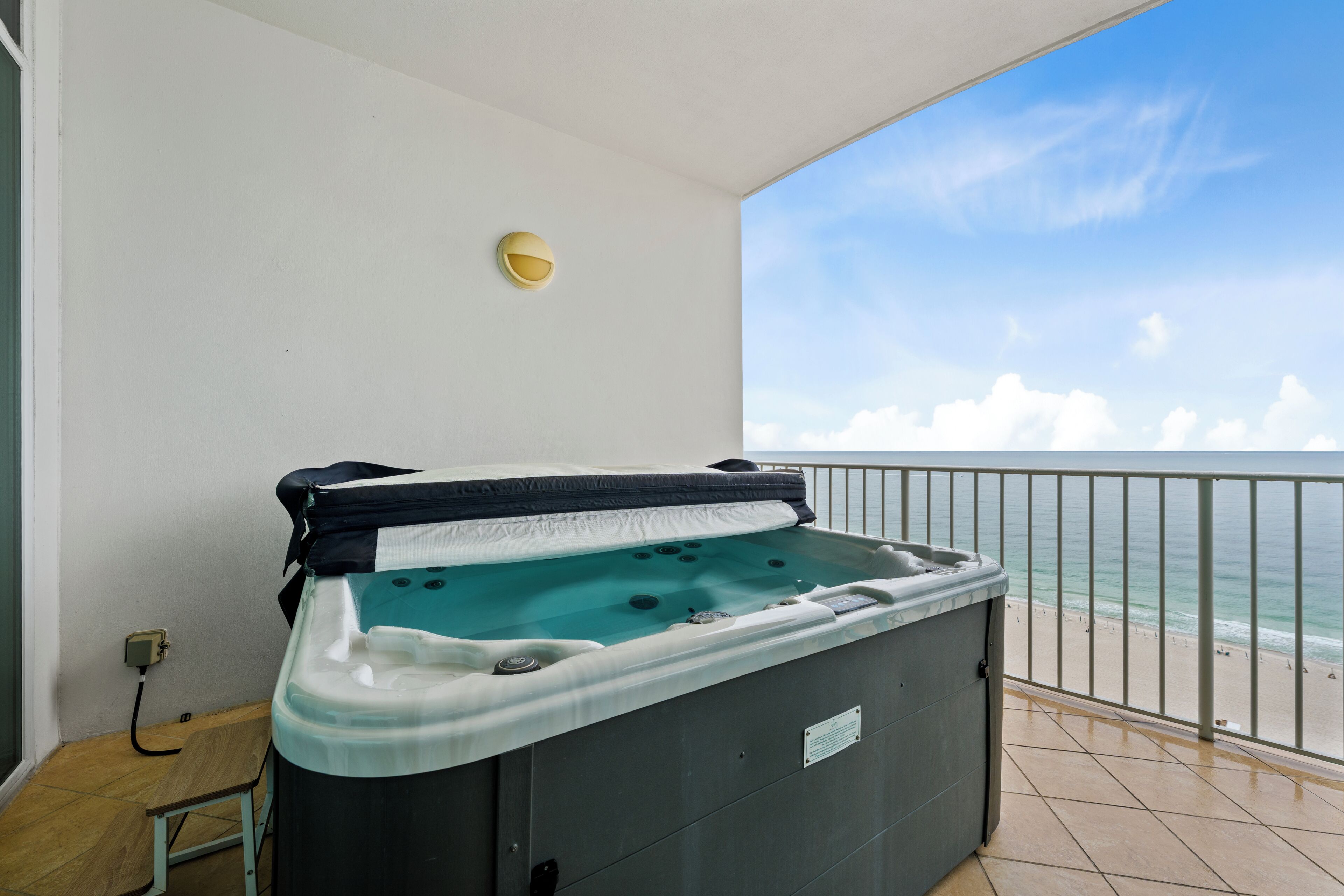 A hot tub on a balcony with a view of the ocean.