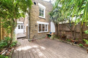Enjoy a serene retreat surrounded by lush gardens and a deck.
