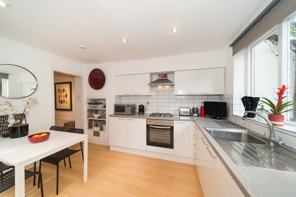 Enjoy cooking in this well-equipped kitchen with a dining area and large window.