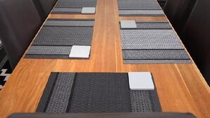 A conference room with a long wooden table, black and beige chairs, and a view of greenery through a window. - Spacious home with 8 beds, perfect for work trips or family stays. Enjoy the comfort of free parking, fast Wi-Fi, and a fully equipped space to relax or get things done. (Southampton)