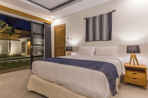 Relax in this serene bedroom with a large bed, bedside tables, and a window offering a view of the outdoor area.