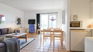 A modern apartment with a living room, dining area, and kitchenette. - "Tinke" - 150m from the sea by Interhome (Løkken)