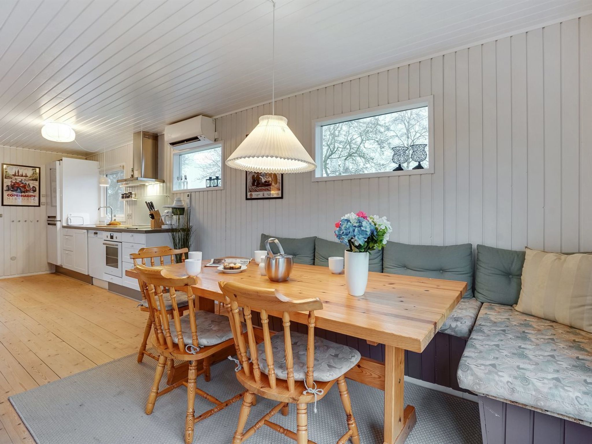 A cozy kitchen with wooden furniture, a dining table, and a bench.