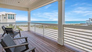 Una terrazza riparata con vista sulla spiaggia e sull'oceano.