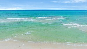A beach with clear turquoise water and a sandy shore. - Ultimate 8-Bedroom Getaway for Families & Groups (Inlet Beach)