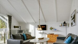 A modern living room with a sofa, a coffee table, and a TV. - "Hortensia" - 350m from the sea by Interhome (Egernsund)