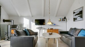 A modern living room with a fireplace, sofas, a TV, and a dining table. - "Hortensia" - 350m from the sea by Interhome (Egernsund)