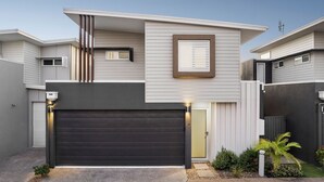 A modern two-story house with a dark garage door, a small window with blinds, and a light fixture above the door. - Spirit of Allura - Located in the beautiful Coolum Beach (Coolum Beach)