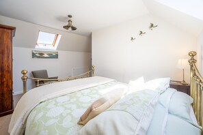 Makuuhuoneessa on sänky, ikkuna, tuoli ja patteri.