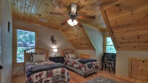 A bedroom with two beds, a desk, and a chair. - Amber Sunsets dazzles with panoramic views, hot tub luxury, a custom firepit, screened porch, pool table, and pet-friendly hospitality! (Talking Rock)