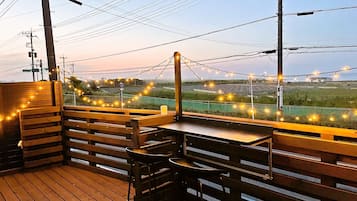 Enjoy a meal with a view of rolling fields and a distant building from our outdoor seating area.