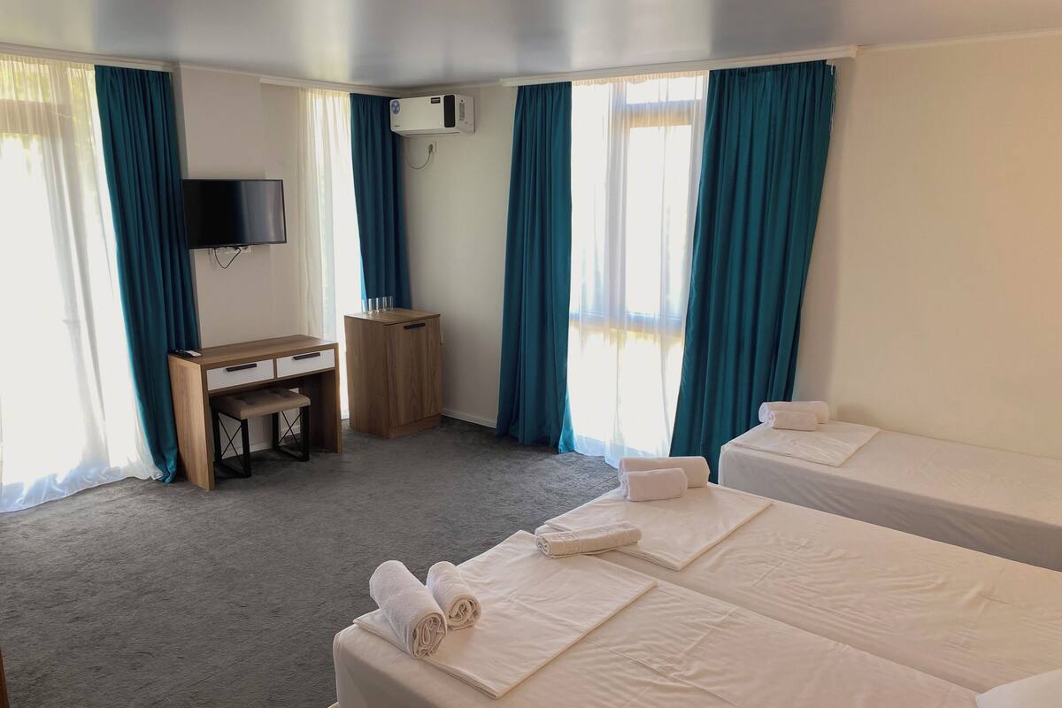 Deluxe Quadruple Room, Sea View | Pillow-top beds, desk, laptop workspace, free WiFi
