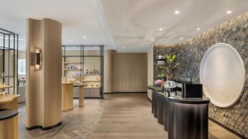 Welcome to our reception area, featuring a central desk, symmetrical pillars, and a patterned tile wall.