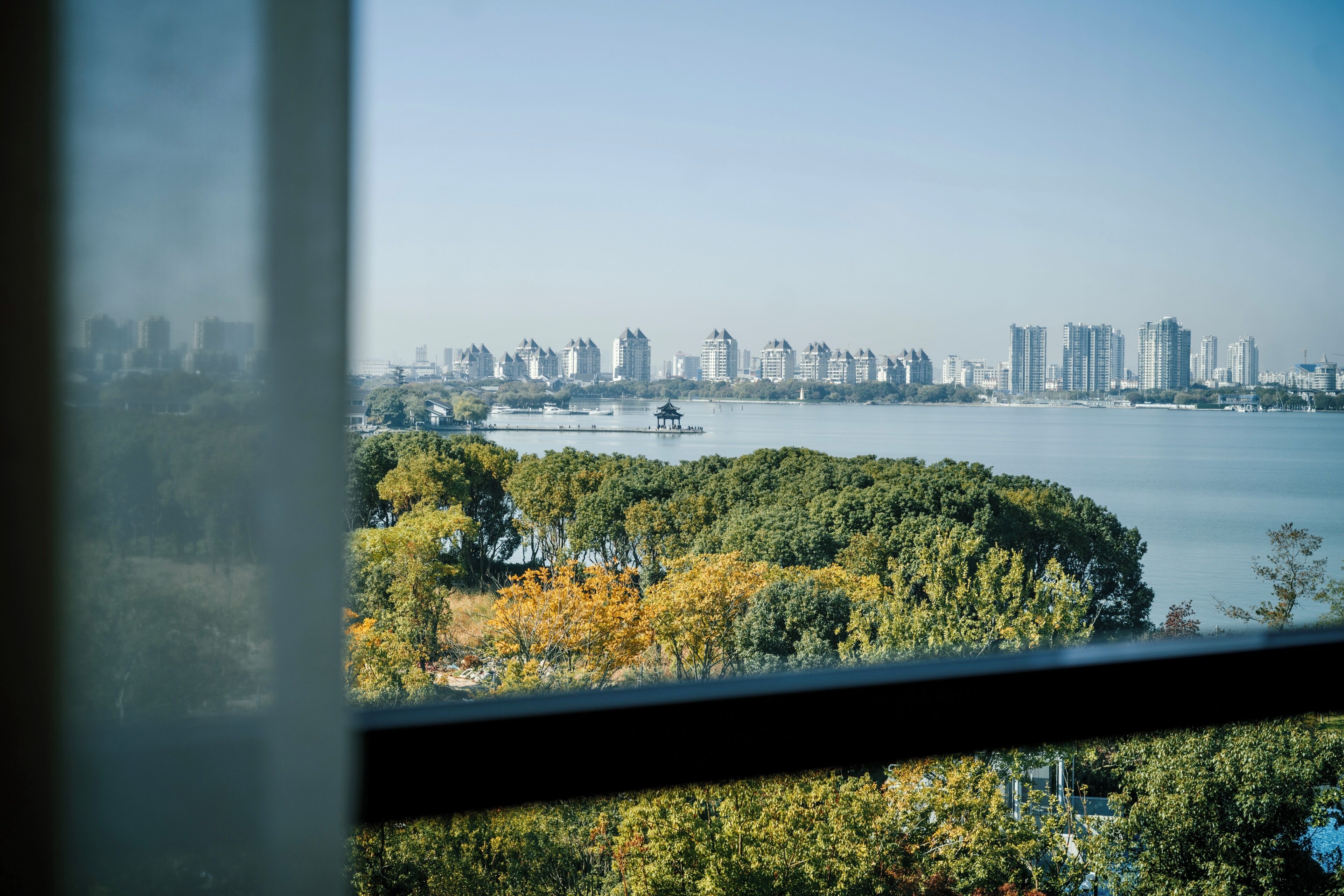 A view of a city skyline with high-rise buildings and a body of water.