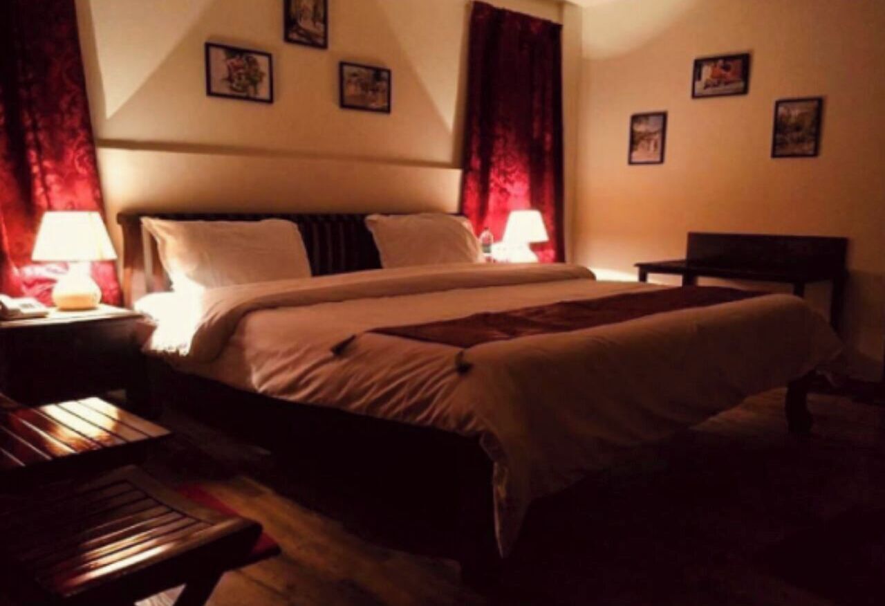 Desk, iron/ironing board, bed sheets