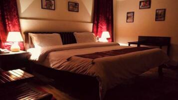 Desk, iron/ironing board, bed sheets