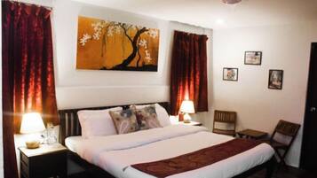 Desk, iron/ironing board, bed sheets