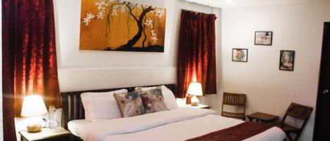 Desk, iron/ironing board, bed sheets