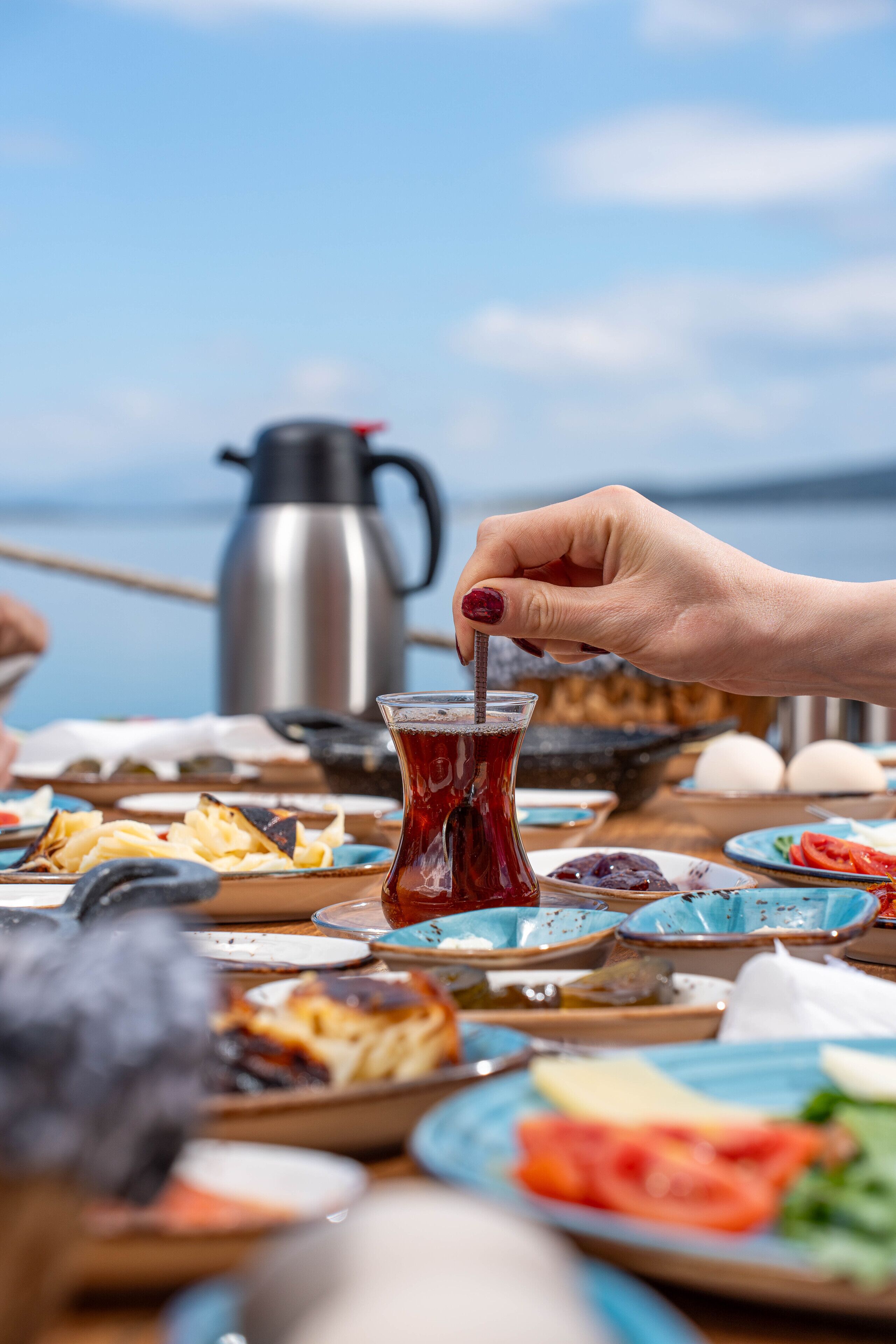 A table with various dishes and a coffee pot, suggesting a dining setting.