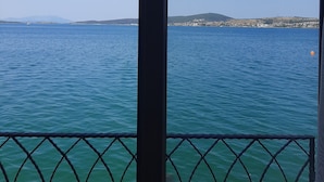 A view of a calm sea with a distant shoreline and a clear sky. - Casalyma Ayvalık (Ayvalik)