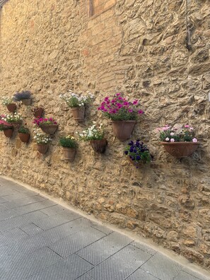 A stone wall with multiple flower planters.
