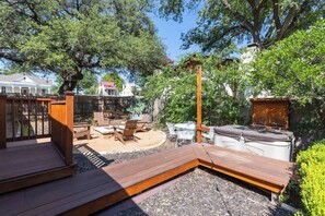 A wooden deck with outdoor furniture, a barbecue grill, and a hot tub. - Two Unit Oasis w/Hot Tub + 3 Blocks to Marktplatz! (Fredericksburg)