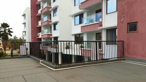A multi-story residential building with balconies, a gated courtyard, and a red and white facade. - Mombasa County (Mombasa)