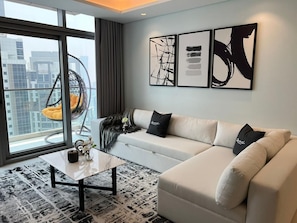 A modern living room with a sofa, a coffee table, and artwork on the wall.