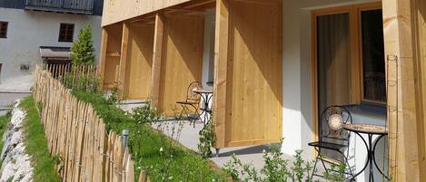 Ein Holzbalkongebäude mit Balkonen, einem Schild mit der Aufschrift „DEPRENDANCE 2“ und Außenplätzen.