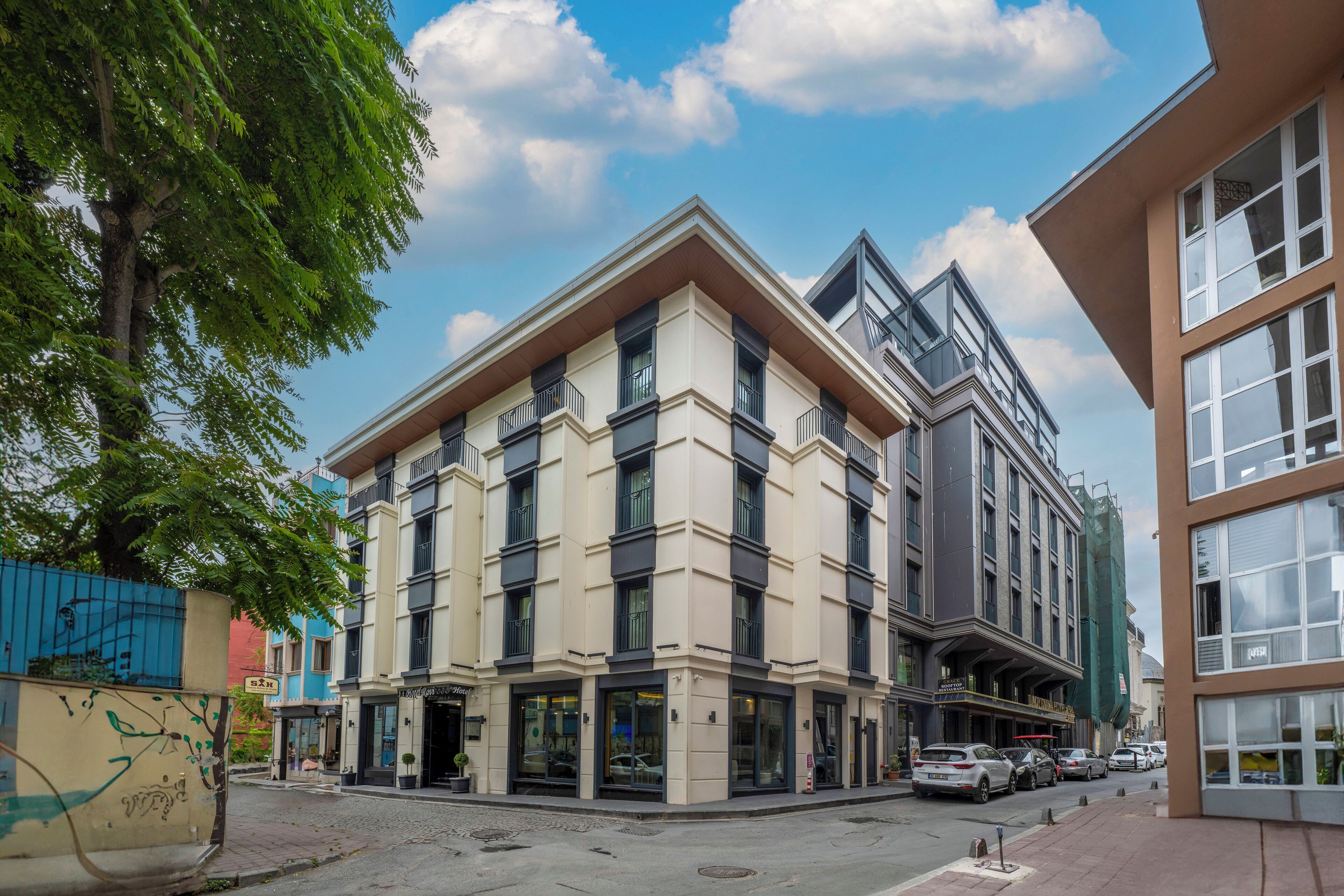 A multi-story building with a corner entrance, large windows, and a visible ground floor with a storefront.