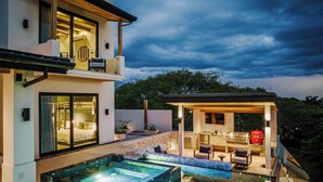 A modern house with a swimming pool, outdoor seating, and a covered patio. - Staffed Luxury Oceanview Villa w/ golfcart, jacuzzi, infinity pool &breakfast (Playa Tamarindo)