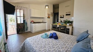 A compact bedroom with a bed, pillows, and a bedside table. - Case Vacanza Rena Majore (Aglientu)