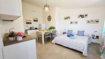 Panoramic Studio, Kitchenette, Sea View | Living area | Flat-screen TV