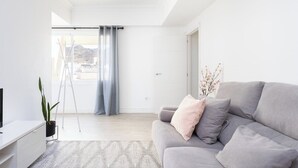 A modern living room with a grey sofa, a small table, and a plant. - Home2Book Stylish & Bright Apt, Santa Cruz Center (Santa Cruz de Tenerife)