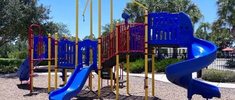 A playground with multiple slides and climbing structures.