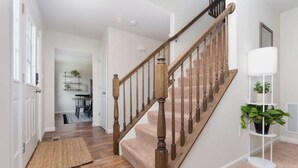 A staircase with wooden balusters and a carpeted landing.