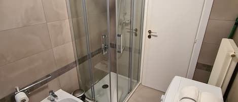 Een douche, een haardroger, een bidet, handdoeken