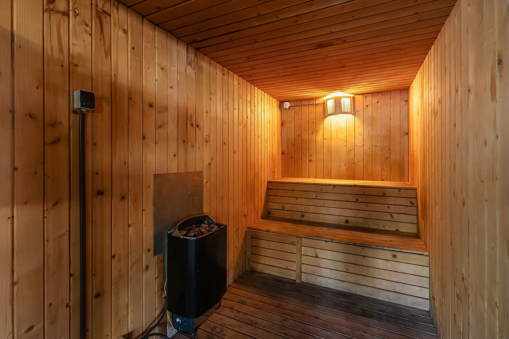 A sauna with wooden walls and a bench.