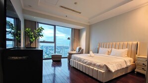 A modern hotel room with a large bed, a sitting area, and a view of the city. - The Rixx Vincom Center (Ho Chi Minh City)