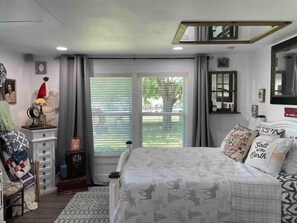 Relax in this inviting space with a large bed, nightstand, and dresser.