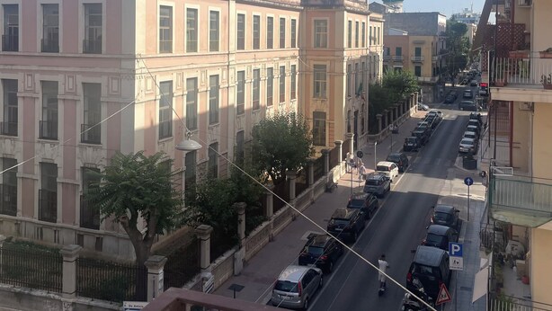 A street view with buildings, parked cars, and a pedestrian crossing. - chiesa russa (Bari)