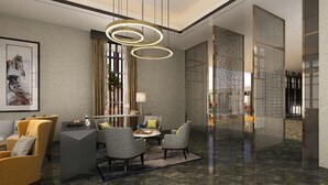 A modern lobby with a marble floor, a round table with chairs, and a large chandelier. - The Rixx D1 Mension (Ho Chi Minh City)