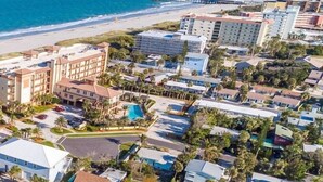 A coastal hotel area with multiple buildings, a beach, and a swimming pool. - Wonderful Place w/Private Patio Next to the Beach (Cocoa Beach)