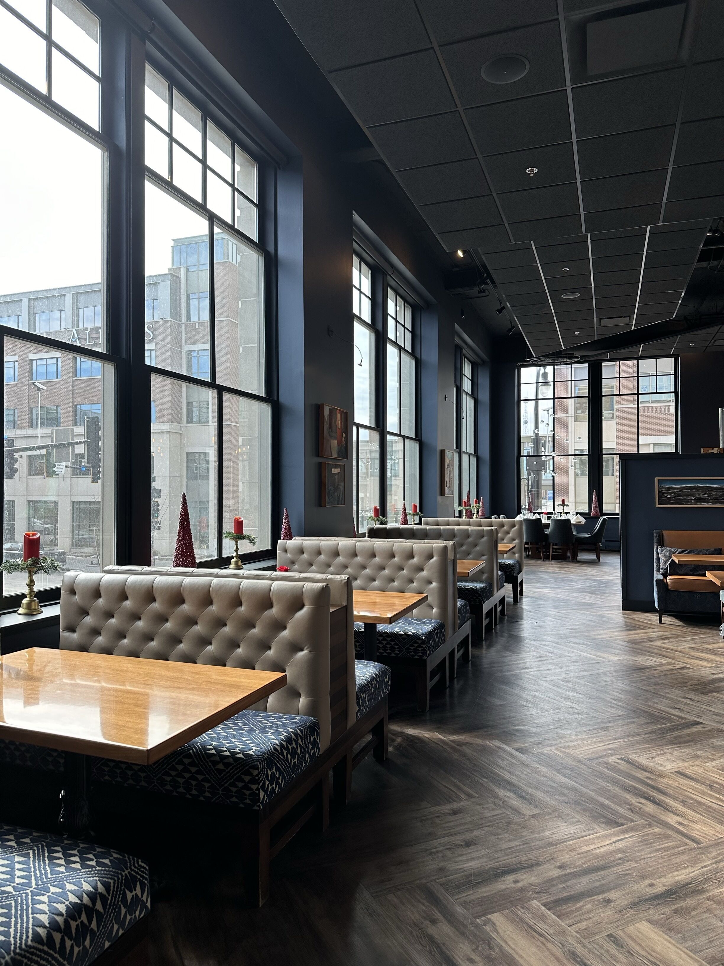 A restaurant with high ceilings, large windows, and a modern interior.