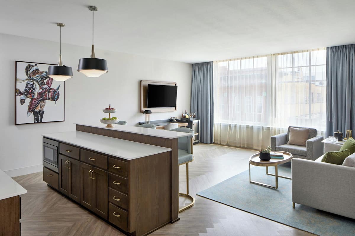 A modern living room with a sofa, a coffee table, and a TV.