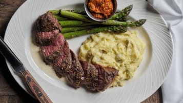 A plate with steak, asparagus, and mashed potatoes.