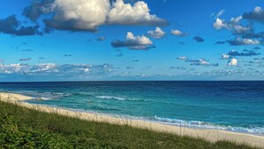 A beach with clear skies and ocean waves. - Aqua Village Resort (Stocking Island)